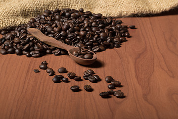 Image showing pile of fresh and bio aromatic coffee beans and spoon