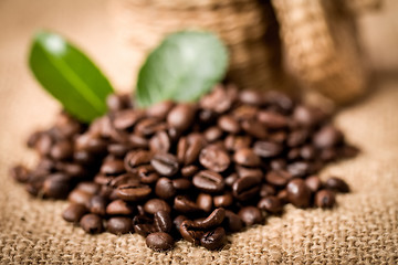 Image showing pile of fresh beans and green leaves and spoon in jar