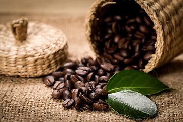 Image showing pile of fresh beans and green leaves and spoon in jar