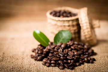 Image showing pile of fresh beans and green leaves and spoon in jar