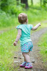 Image showing Cute Little girl walking away on the road ahead