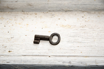 Image showing Vintage key at dirty white surface