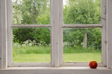 Image showing Red apple at an old windowsill