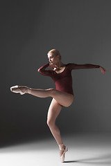 Image showing Young beautiful modern style dancer posing on a studio background