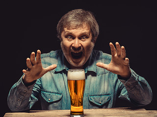Image showing The screaming man in denim shirt with glass of beer
