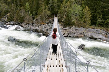 Image showing Woman on suspension bridge