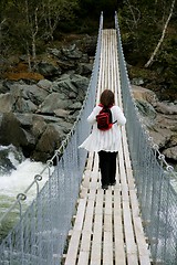 Image showing Woman on a suspension bridge
