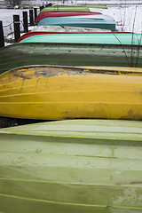 Image showing colorful boats in winter on shore