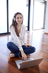 Image showing relaxed young woman at home working on laptop computer