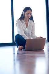 Image showing relaxed young woman at home working on laptop computer