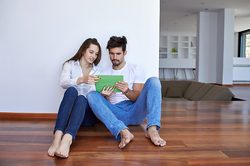 Image showing couple at modern home using tablet computer