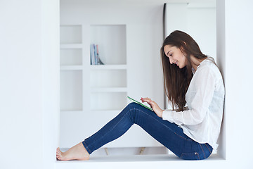 Image showing woman at home using tablet