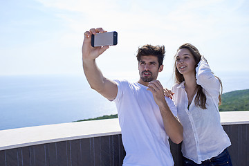 Image showing young couple making selfie together