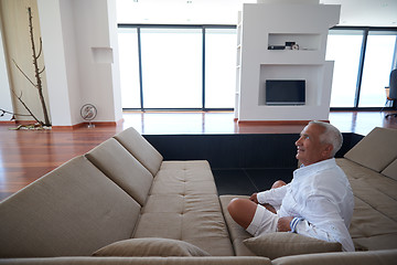 Image showing Portrait of senior man relaxing in sofa