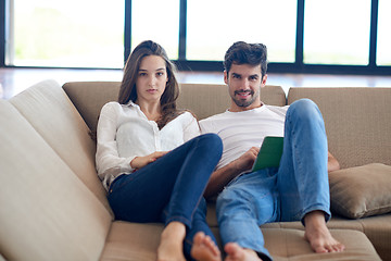 Image showing couple at modern home using tablet computer