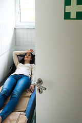 Image showing Young woman is relaxing in a quiet room of an office