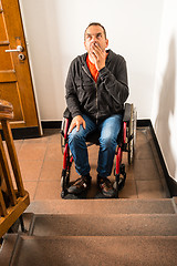 Image showing man in wheelchair facing a barrier of stairs