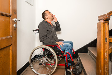 Image showing man in wheelchair facing a barrier of stairs