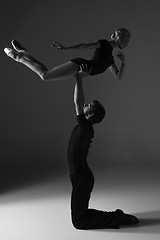 Image showing two young modern ballet dancers on gray studio background 