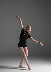 Image showing Young beautiful modern style dancer posing on a studio background