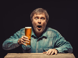 Image showing The enchanted and emotional fan with glass of beer