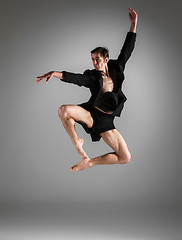 Image showing The young attractive modern ballet dancer jumping on white background