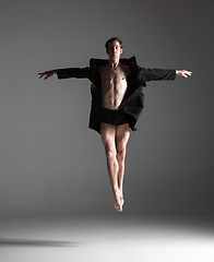 Image showing The young attractive modern ballet dancer jumping on white background