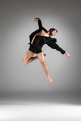 Image showing The young attractive modern ballet dancer jumping on white background