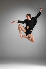 Image showing The young attractive modern ballet dancer jumping on white background