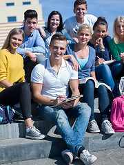 Image showing students outside sitting on steps