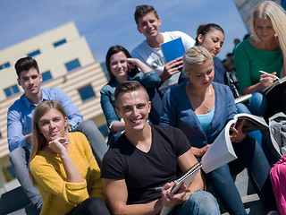 Image showing students outside sitting on steps