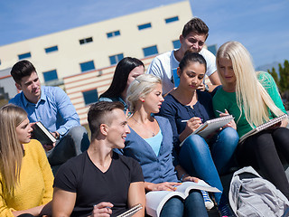 Image showing students outside sitting on steps