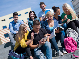 Image showing students outside sitting on steps