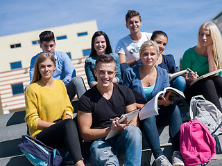 Image showing students outside sitting on steps