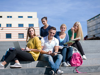 Image showing students outside sitting on steps