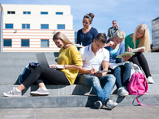 Image showing students outside sitting on steps