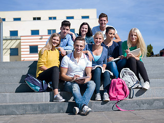 Image showing students outside sitting on steps