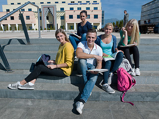 Image showing students outside sitting on steps