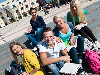 Image showing students outside sitting on steps