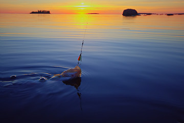 Image showing Sunset river perch fishing with the boat and a rod