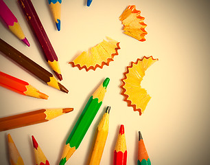 Image showing several colored pencils and shavings on white background