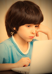 Image showing child looking at a computer monitor