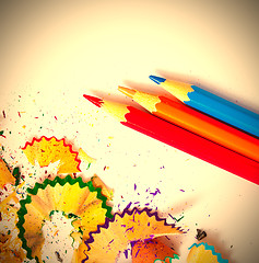 Image showing three colored pencils and shavings