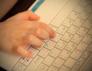 Image showing child\'s hand on the laptop keyboard