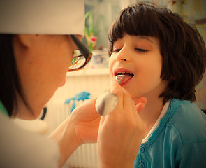 Image showing doctor otolaryngologist looking boy throat