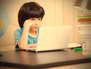 Image showing boy looking at a computer monitor