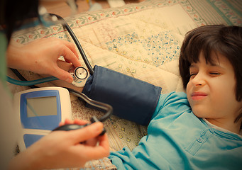 Image showing Doctor pediatrician measure blood pressure