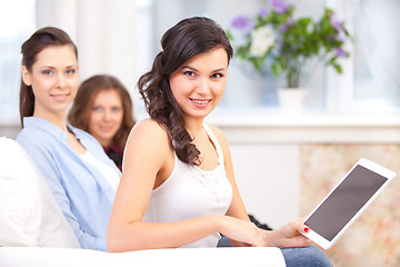 Image showing smiling young girl with tablet