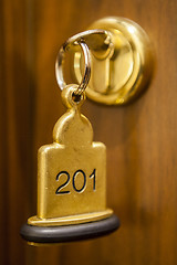 Image showing Hotel Room Key lying on Bed with keyring