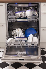 Image showing Dishwasher loades in a kitchen with clean dishes